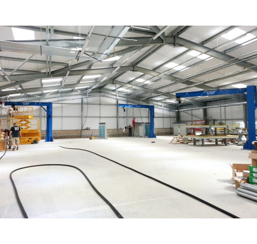 trio of swing jib cranes in a factory